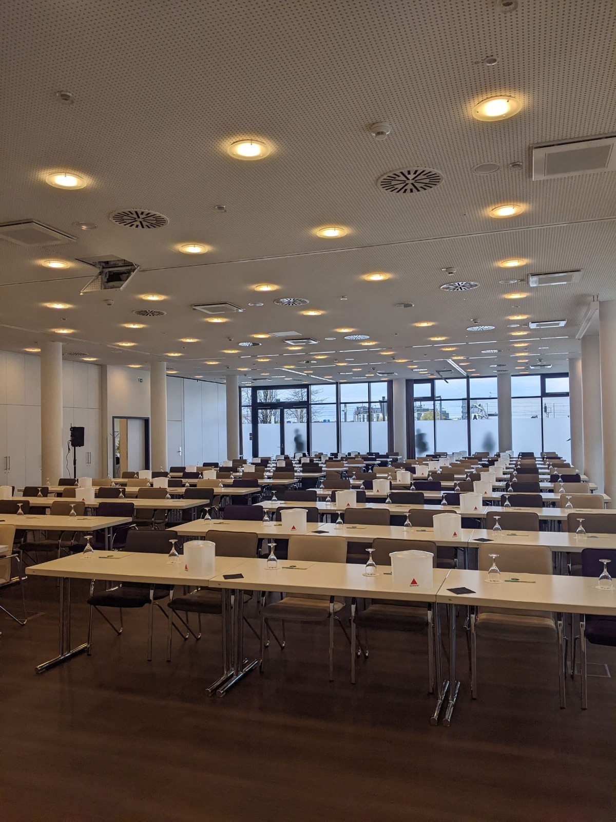 Conference stage with branded lighting and rows of seating.