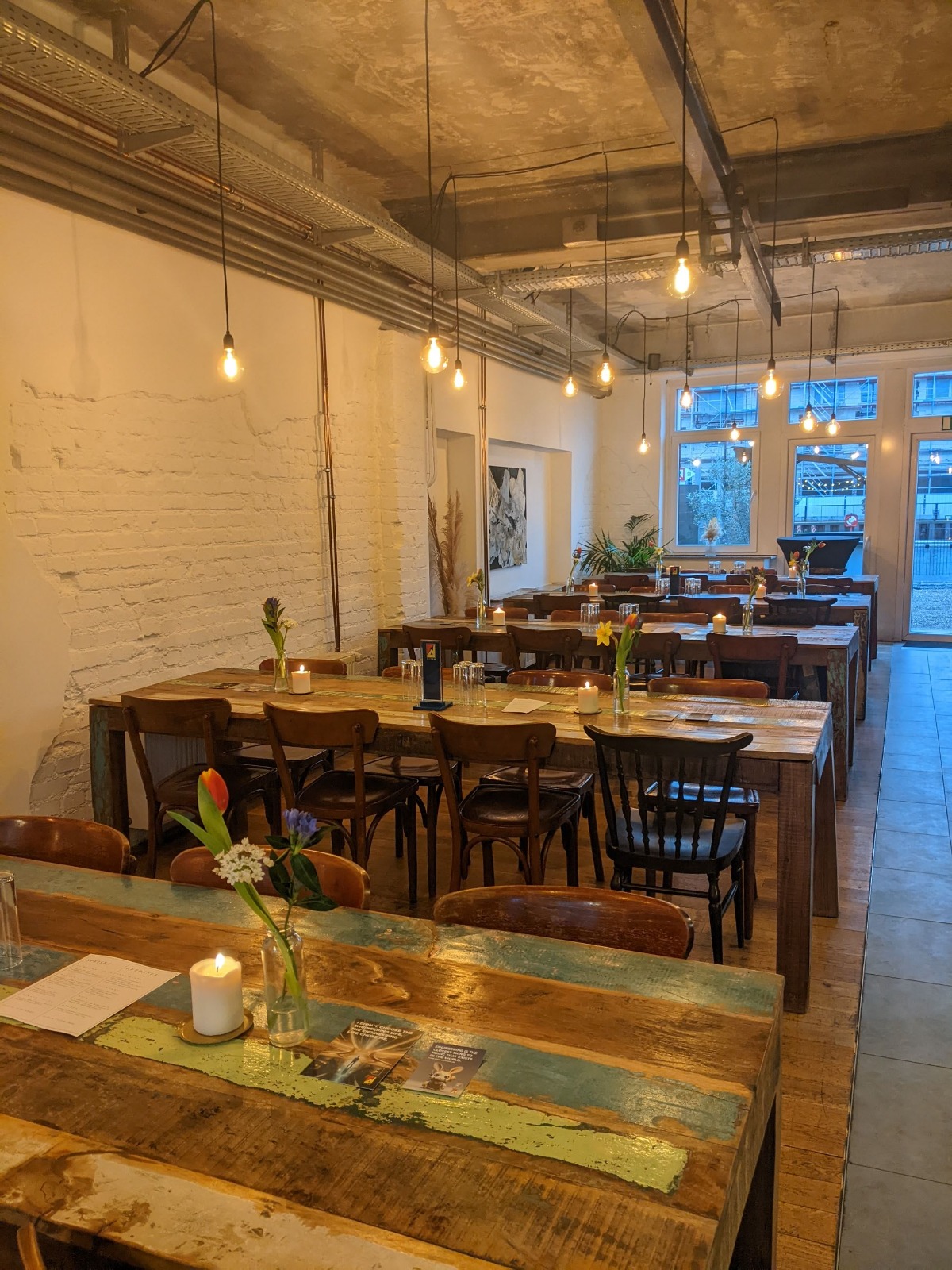 Intimate dining table styled with candles and soft florals.