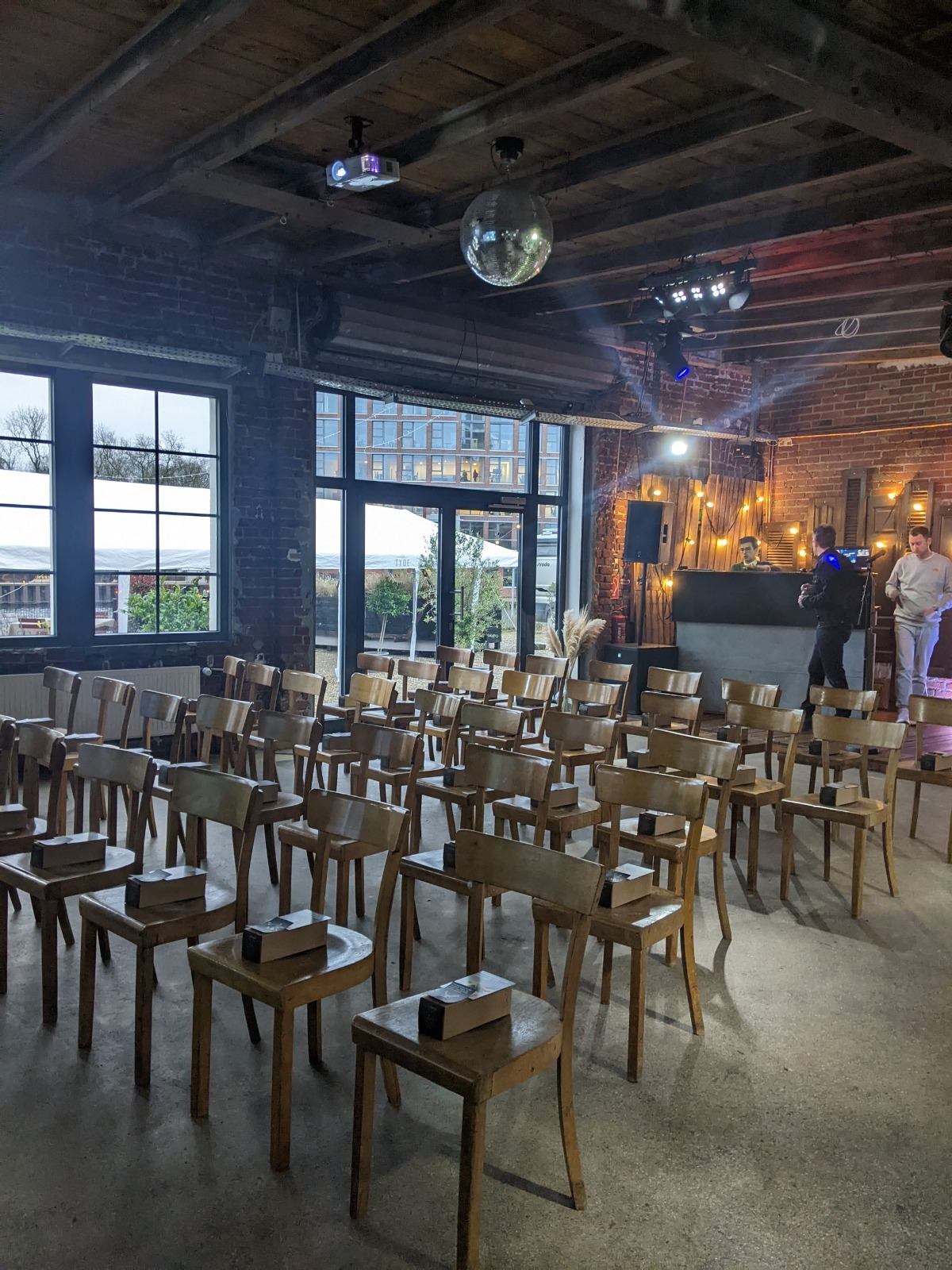 Rustic seating vignette accented with greenery and candlelight.