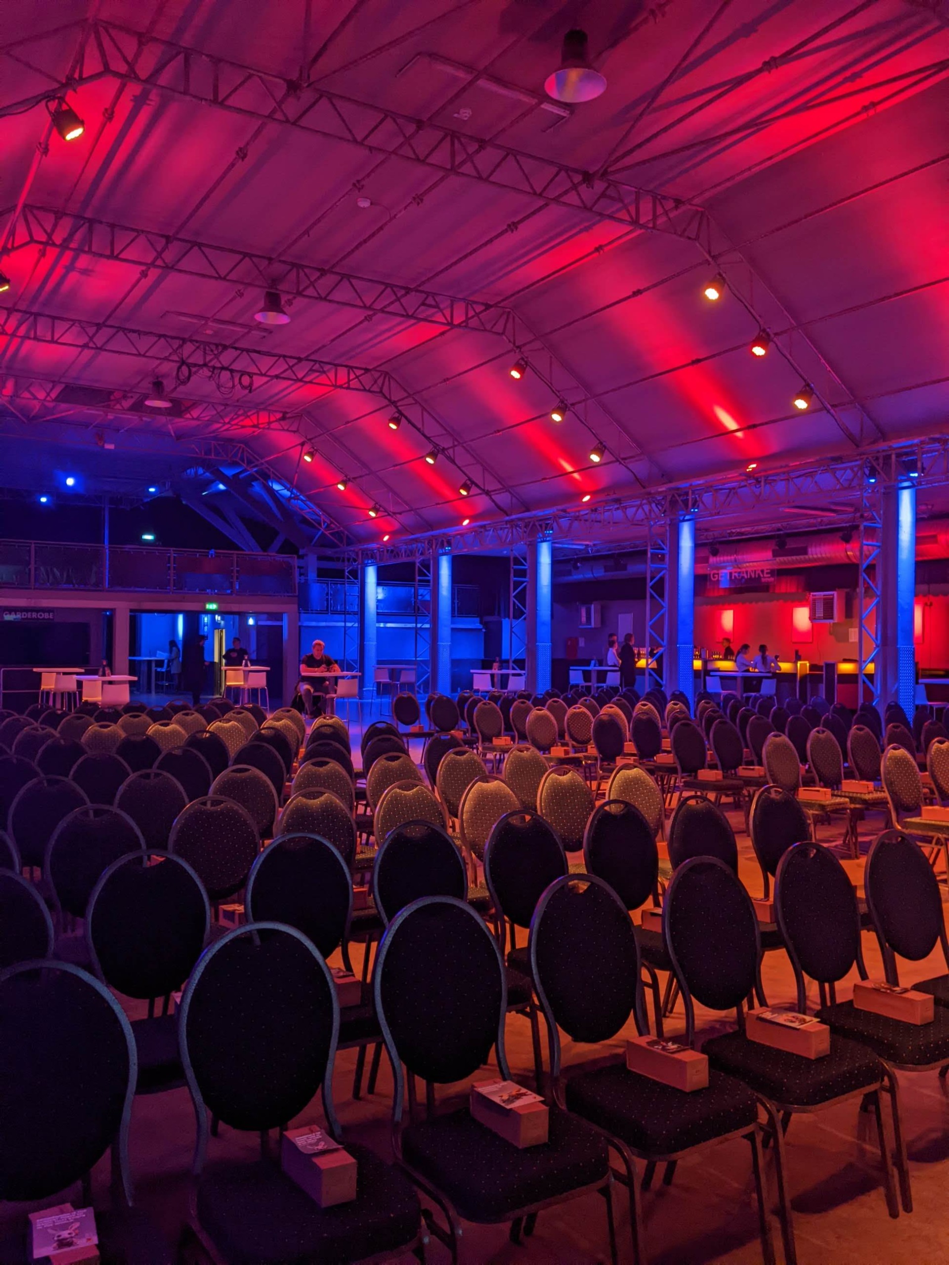 Stage seating dressed with lush greenery and warm lighting.