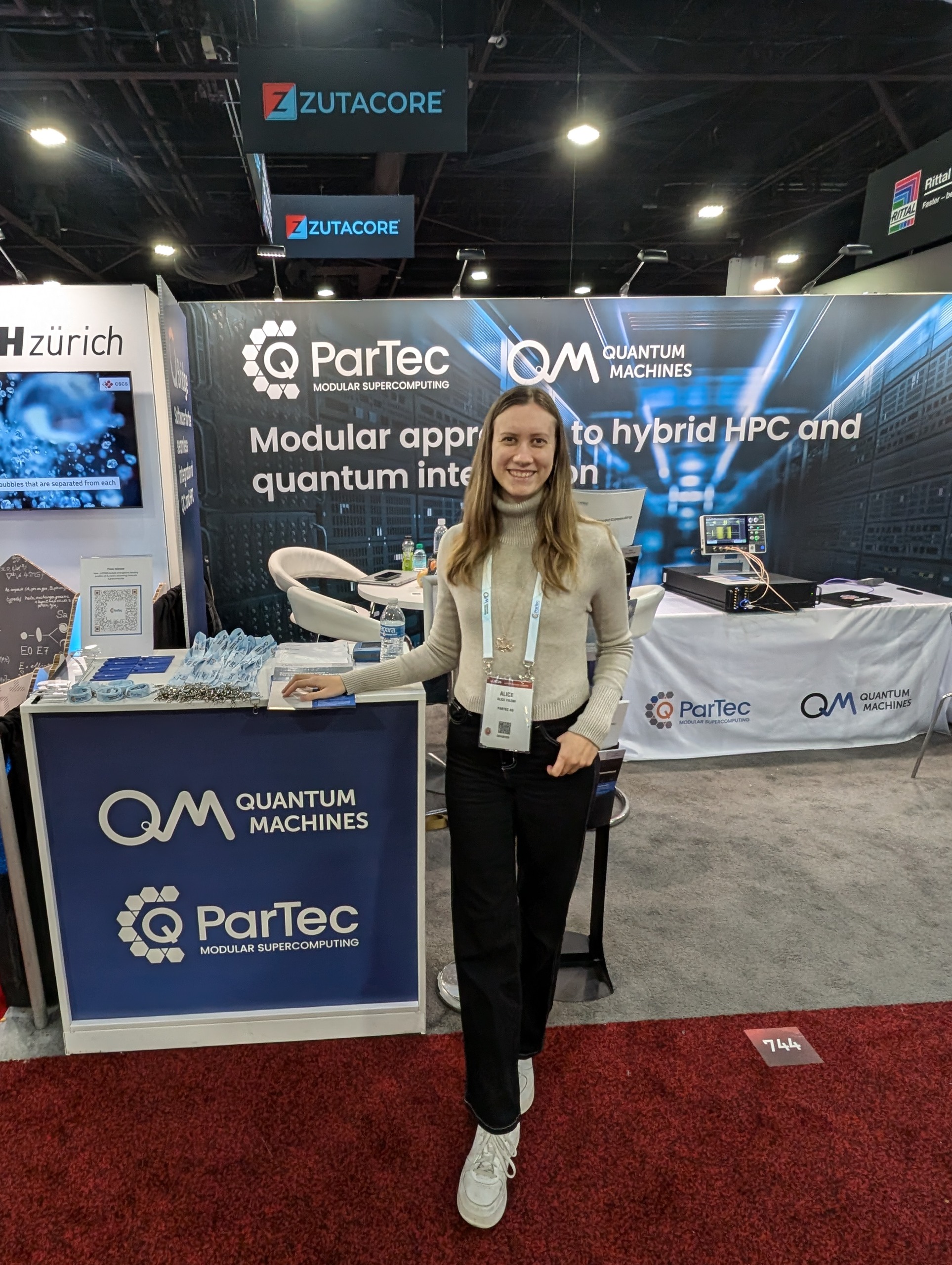 Technology expo floor featuring interactive displays and dramatic lighting.